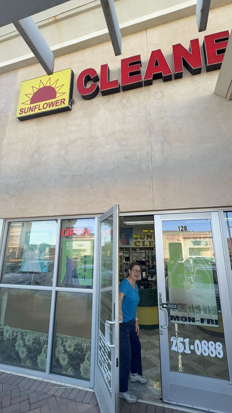 The front door of Sunflower Cleaners, Suite 120, with the owner welcoming customers