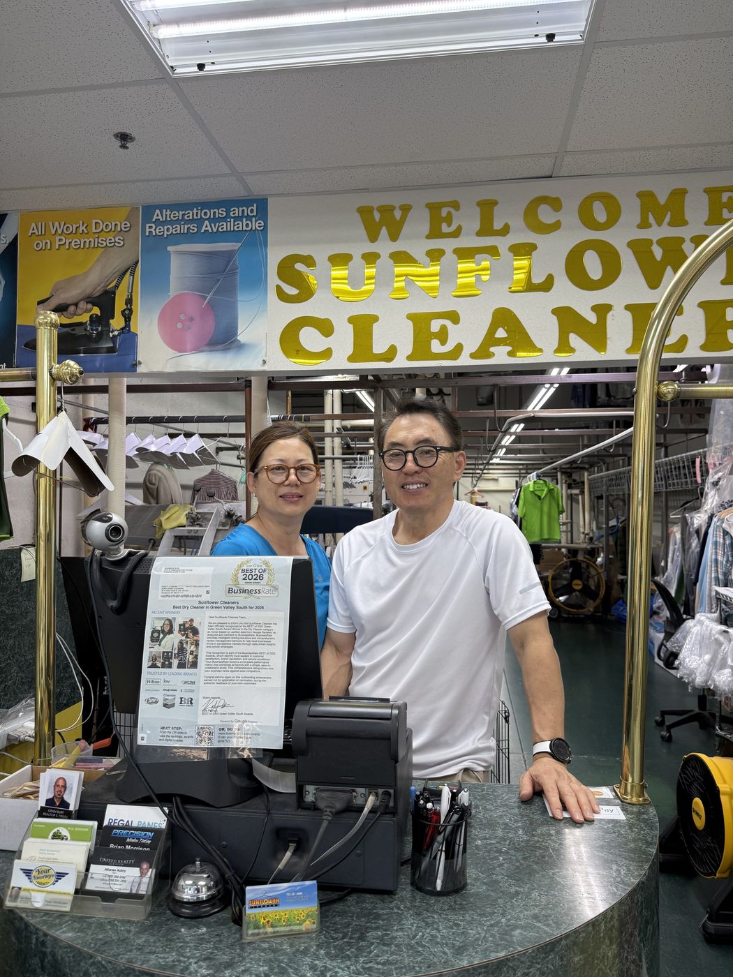 The husband-and-wife owners of Sunflower Cleaners behind their front counter